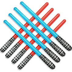 six blue and red plastic darts are lined up