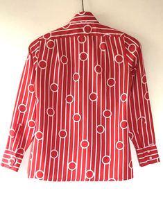 "True vintage top, featuring all over bold red and white geometric pattern, topped with a stately winged collar and classic button up placket. Designer label removed. Approximate Measurements: Shoulder: 14\"; Chest: 35\"; Length: 24.5\"; Labeled a Size 8 Fabric: 100% polyester Eye catching retro blouse, circa 1960s, is in excellent vintage condition. Enjoy! *(International Buyers are welcome - however, please email me so I can check the shipping rate for you before committing to buy.) bt"