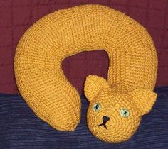 there is a knitted bear head on top of a pillow with the letter o