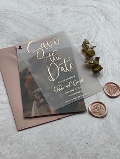 a wedding save the date card next to some coins