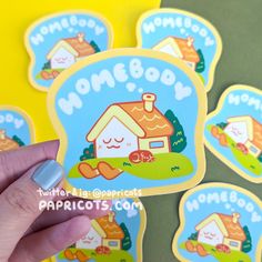 someone is holding up some stickers to show their house and dog designs on them