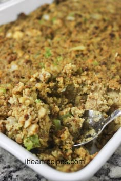 a casserole dish with broccoli and stuffing in it