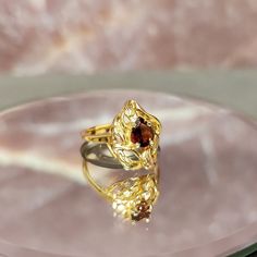 Step back in time with our exquisite Vintage 10k Gold Freeform Ring, featuring a mesmerizing Pear Cut Garnet. This timeless piece of fine jewelry exudes elegance and charm, perfect for adding a touch of vintage glamour to any ensemble. Crafted with care and attention to detail, this ring boasts a unique freeform design that sets it apart from the ordinary. The lustrous 10k gold band adds a luxurious touch, while the pear-cut garnet gemstone sparkles with rich hues of red, reminiscent of a deep s Fine Jewelry Yellow Gold Topaz Teardrop Ring, Fine Jewelry Yellow Gold Topaz Ring With Teardrop, Teardrop Gemstone Ring For Formal Occasions, Elegant Marquise Ruby Ring With Diamond Cut, Formal Yellow Gold Topaz Teardrop Ring, Pear-shaped Yellow Gold Topaz Ring, Elegant Yellow Gold Birthstone Ring With Polished Finish, Elegant Pear-shaped Yellow Gold Birthstone Ring, Elegant Yellow Gold Pear-shaped Ring