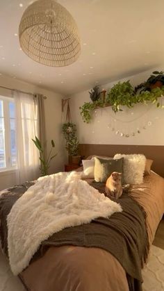 a bedroom with a large bed and plants on the wall