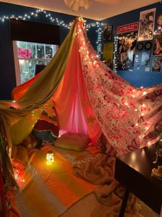 a bedroom with a canopy and lights on the ceiling