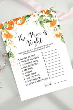 the price is right wedding game with oranges and flowers on it, next to a pink ribbon