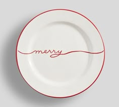 a white plate with the word merry written in red ink on it's side