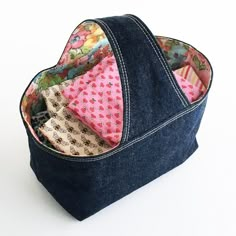 the inside of a denim tote bag filled with fabric and folded up in different patterns