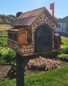 a mailbox with a giraffe print on it in front of some flowers