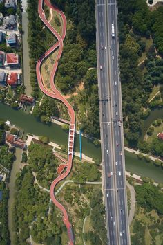 an aerial view of a curved road in the middle of a city