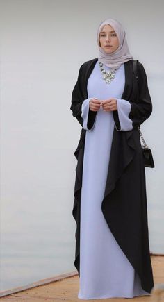 Introducing Annah Hariri's Exquisite Abaya Dress - a perfect blend of tradition and modern elegance in Blue & Black. Designed with impeccable craftsmanship, versatility, and adaptability, this dress celebrates the beauty and grace of the wearer. Available as a kimono abaya or elegantly designed eid abaya, it is a treasure in your wardrobe for any occasion. Experience unmatched elegance with Annah Hariri. HN022 Islamic Clothing Women, Navy Blue Abaya Design, Blue Fitted Floor-length Abaya, Black Open Abaya, Pink Heart Dress, Elegant Embroidered Black Abaya, Abaya Kimono, Black Embroidered Floor-length Abaya, Black Prom