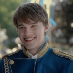 a man in blue uniform smiling at the camera