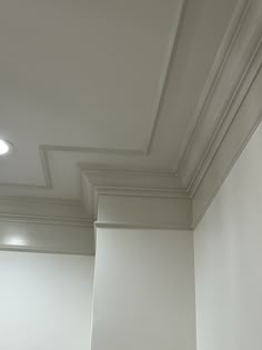 an empty room with white walls and ceiling