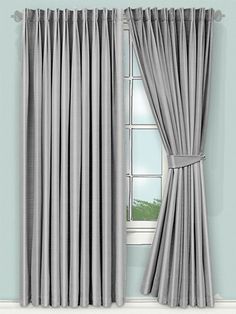 an open window with curtains in front of it and the curtain is pulled back from the wall