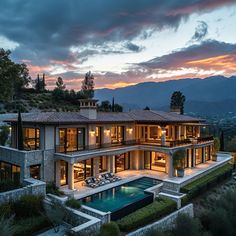 an aerial view of a house with a pool in the foreground and mountains in the background