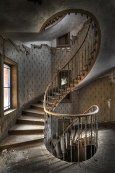 a spiral staircase in an abandoned building