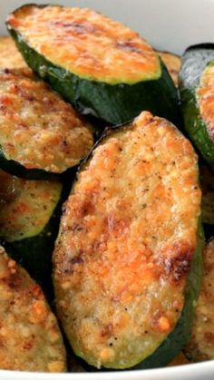 cooked zucchini slices in a white bowl on a table top with seasoning