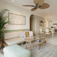 a living room filled with lots of furniture and a ceiling fan above the couches