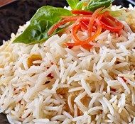 a plate topped with rice and vegetables on top of a table