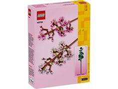 a pink box with some flowers on the side and a lego sticker in it