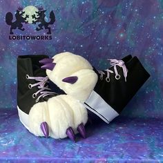 a white stuffed animal with purple and black shoes