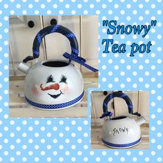 a snowman tea pot with a blue ribbon around it