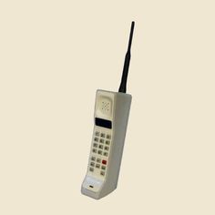 an old style cell phone is shown in the air with its antenna attached to it