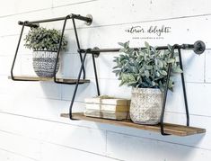 two metal shelves with plants and books on them against a white painted wall that says, home delightful