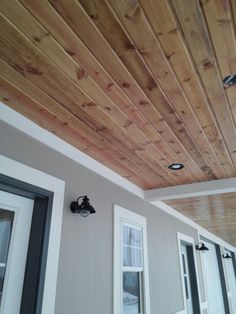 the inside of a house with wood paneling on the ceiling