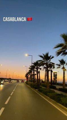 a street with palm trees on both sides and the words cassblanca above it