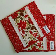 two red and white placemats sitting on top of each other