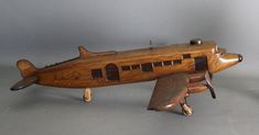 a wooden toy airplane sitting on top of a table