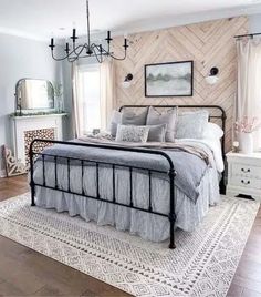 a bedroom with a bed, dresser and chandelier