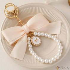 a white plate topped with pearls and a keychain