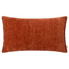 an orange pillow on a white background