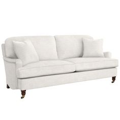 a white couch with two pillows on it's back and one arm facing the camera