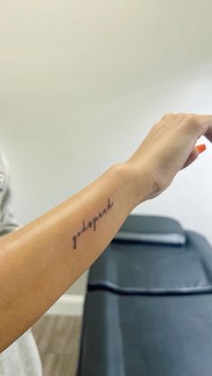 a person with a small tattoo on their arm