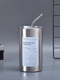 a metal can with a straw sticking out of it