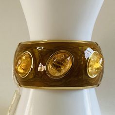 Beautiful vintage Francesca Romana Diana cracked citrine cabochon hinged bangle bracelet in excellent condition (from when she signed her pieces only Francesca Romana). Measures 35 mm wide. New and unworn. Comes with original tag, bag and box. Francesca Romana is an Italian designer who loves Brazilian culture and has found success among her Latin American clientele. She uses Brazilian semi-precious stones in her designs. Francesca Romana is one of the best known jewelry designers in Brazil. She Luxury Citrine Cabochon Jewelry, Brown Bangle Jewelry For Formal Occasions, Brown Bangle For Formal Occasions, Elegant Brown Bangle For Formal Occasions, Elegant Formal Brown Bangle, Modern Lucite Bangle Jewelry, Gold Cabochon Bangle Jewelry, Formal Gold Lucite Jewelry, Designer Gold Jewelry With Cabochon