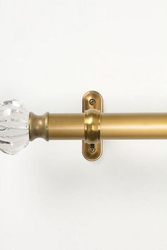 an image of a door handle with glass knobs on the outside and brass finish