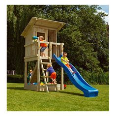 children playing on a wooden play set in the grass with a slide and climbing tower