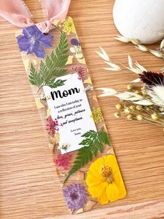 a mother's day card with flowers on it next to some dried plants and an egg