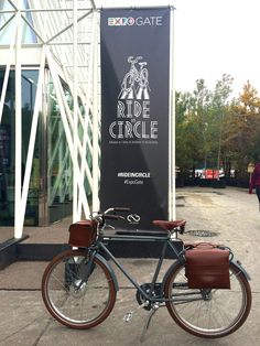 a bicycle parked in front of a building with a sign that says ride circle on it