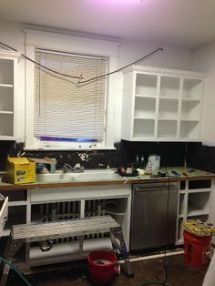 the kitchen is being remodeled with white cabinets