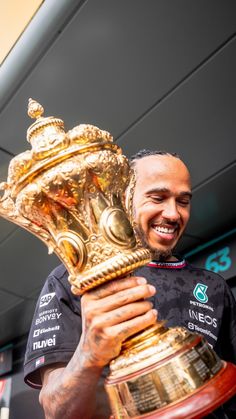 a man holding a trophy in his hands