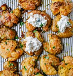 baked potatoes with cream cheese and herbs on a baking sheet, ready to be eaten