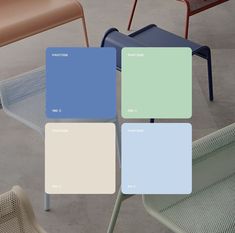 four different colors of chairs and tables on cement flooring with one chair in the middle