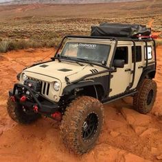 a white jeep is parked in the desert