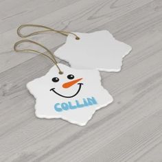 an ornament shaped like a snowman with the word collin on it's face