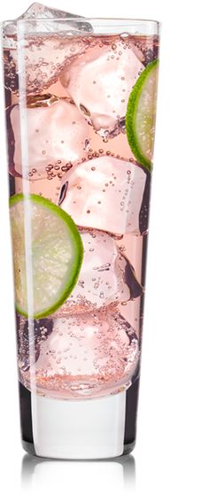 a tall glass filled with ice and lime slices